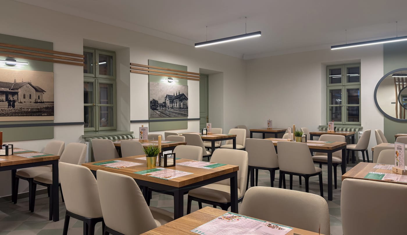 Dining room with wooden tables and sage green walls
